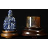 A Chinese lapis lazuli carving, of Buddha, 5.5cm high, hardwood stand; a Chinese russet jade