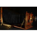 A large early 20th century lacquered brass and mahogany plate camera, "Triple Victo" by Thornton