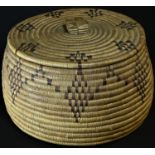 A Native American basket and cover, of traditional construction and decorated with stylised