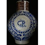A German Westerwald stoneware ovoid jug, centered by a medallion impressed GR crowned, incised