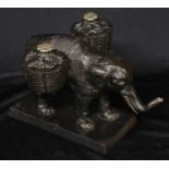 A 19th century cast iron novelty inkstand, as an elephant laden with baskets, rectangular base, 19cm