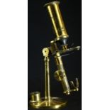 A 19th/early 20th century lacquered brass monocular microscope, rack-and-pinion focus, adjustable