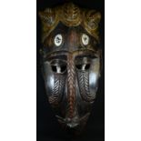 Tribal Art - a West African mask, stylised features with projecting central ridge, elaborate