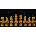 A large boxwood and ebonised chess set, by K&C London, the Kings 10.5cm high and 4.5cm diam at base,