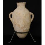 Antiquities - an ancient Near Eastern terracotta amphora, of typical form, tripod display stand,