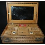 A 19th century Indian sandalwood sarcophagus combination work and writing box, profusely carved with