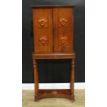 An unusual William IV oak portable cabinet on stand, moulded cornice above a pair of rectangular