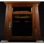 An Art Nouveau oak gentleman's smoking room cabinet, hinged cover and bevelled glazed door enclosing