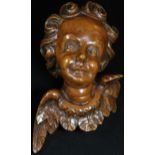 A 19th century Italian limewood carving, of a putto, 17cm long, dated to verso 1865