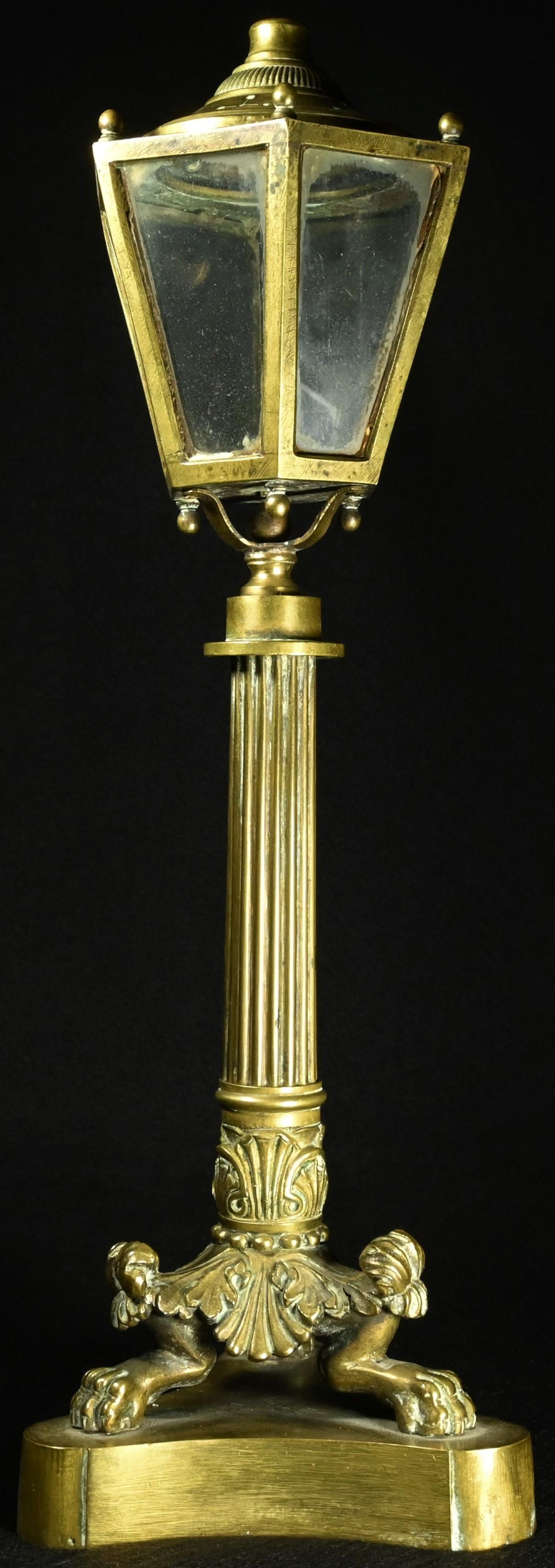 A 19th century bronze table top lantern, glazed hexagonal lamp head, reeded pillar, tripod support