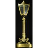 A 19th century bronze table top lantern, glazed hexagonal lamp head, reeded pillar, tripod support