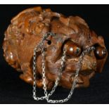 A late 18th/early 19th century coquilla nut 'bug bear', carved with a musician and a portrait