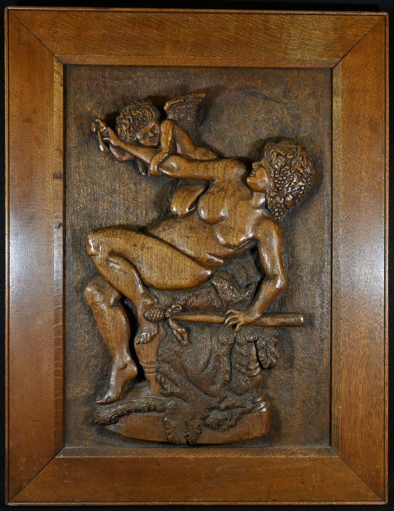 A 19th century provincial oak rectangular panel, in relief with a Bacchante and a putto, 76cm x 59cm