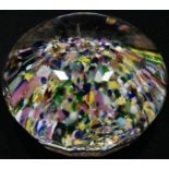 A large glass desk paperweight, probably French, coloured pebble inclusions, viewing facets to side,