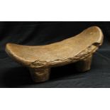 Tribal Art - an African stool or headrest, bowed top, four stout legs, 43cm long, possibly Sudan