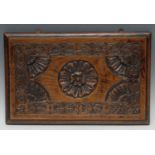 An oak rectangular panel, carved with a Tudor rose, palmettes and fan paterae, 29cm x 45cm, 19th