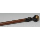 A bronze mounted gentleman's walking stick, as an eagle's claw grasping a ball, tapered octagonal