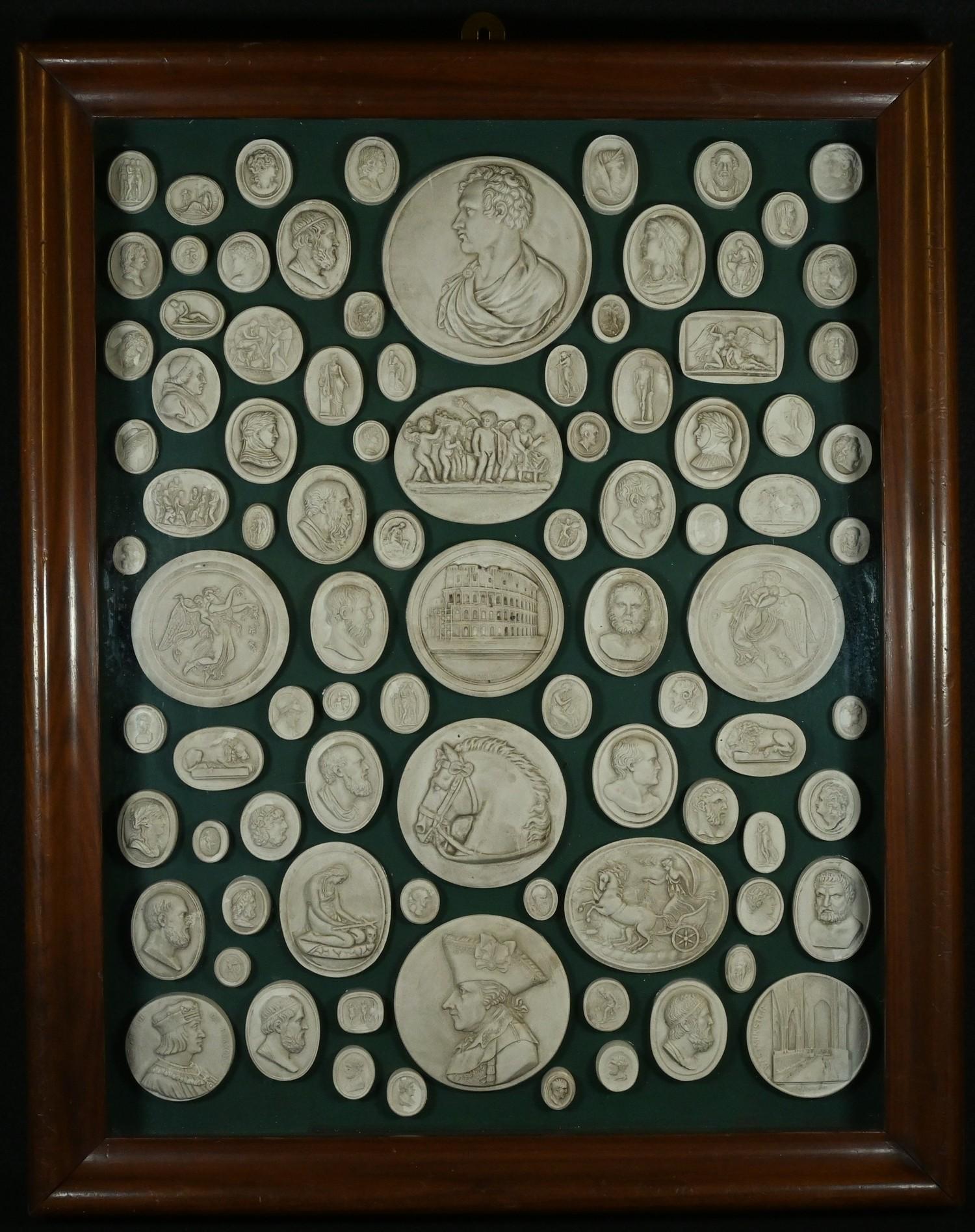 An arrangement of plaster intaglio impressions, various Grand Tour and later subjects, 43.5cm x 33.