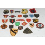 Twenty five Vietnam War 'In Country' made US Army cloth badges
