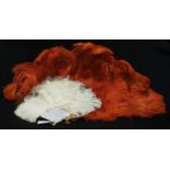 An orange ostrich feather fan, faux tortoiseshell sticks, 70cm long; another (2)