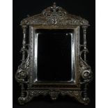 A 19th century Renaissance Revival bois durci easel looking glass, rectangular mirror plate, the