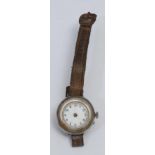 A WWI Officer's wristwatch, broken, with Machine Gun Corps badge engraved on the back