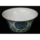 A Chinese wucai flared bowl, painted with stylised trees, flowers and scroll lappets, 16cm diam,