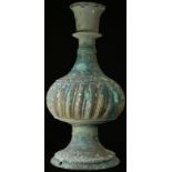 A Middle Eastern hookah base, verdigris patination, fluted and engraved, 28cm high, drilled as a