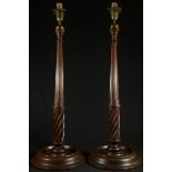 A pair of tall George III Revival mahogany candlesticks, fluted urnular sconces, fluted and spirally