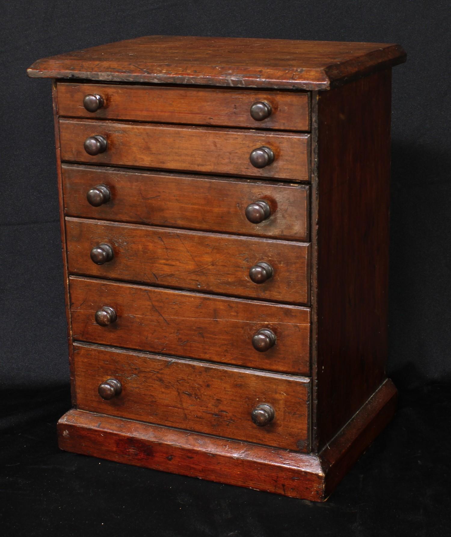 A late Victorian/Edwardian table top watchmaker's chest, oversailing rectangular top above six