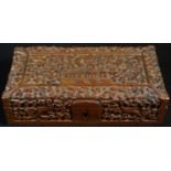 An Indian sandalwood rectangular box, carved with a temple on a ground of scrolling flowering