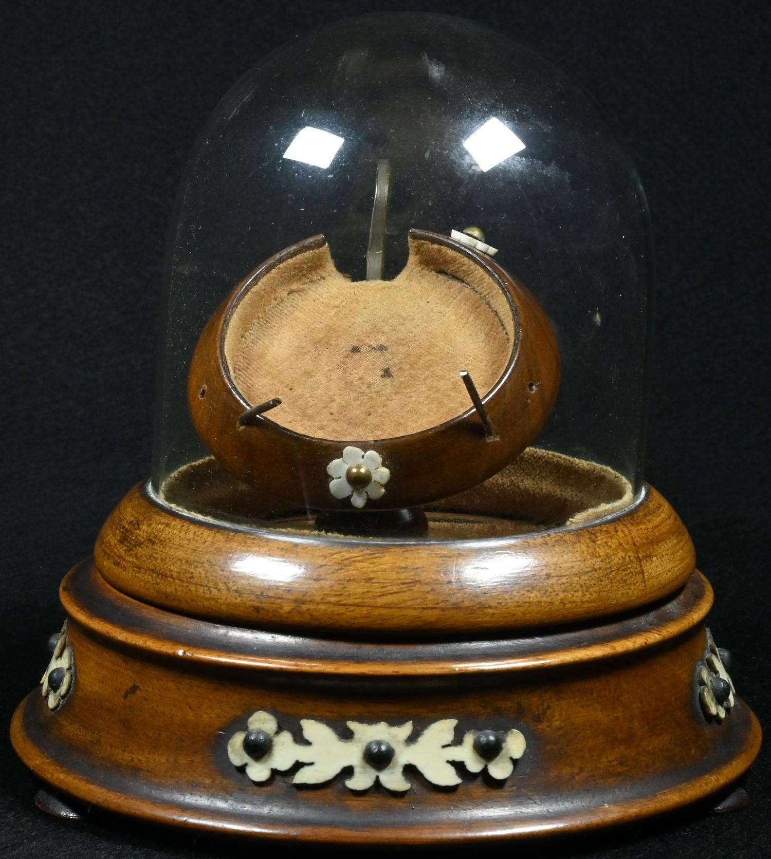 A 19th century pocket watch stand, hinged glass dome, turned base, applied with cut-card work, bun