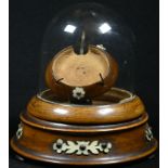 A 19th century pocket watch stand, hinged glass dome, turned base, applied with cut-card work, bun