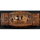 An early 19th century coquilla nut snuff box, carved with figures, flowers and stiff leaves,