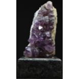 Geology - an amethyst quartz sample, mounted for display, square marble base, 16cm high overall