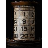 An early 20th century combination desk top pen tidy and perpetual calendar, printed card cylinder,