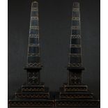 A pair of 19th century ebonised library obelisks, incise-carved and picked out in gilt in the