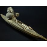 Tribal Art - a North American Inuit kayak model, the sealskin vessel enclosing a fur clad hunter