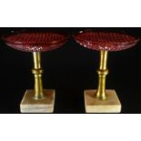 A pair of gilt metal and cranberry glass tazzas, square marble bases, 19cm high