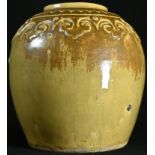 A Chinese monochrome stoneware ovoid ginger jar, the shoulder moulded with a band of lappets, glazed