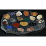 A pietra dura shaped oval desk weight, inlaid in amethyst quartz, lapis lazuli, malachite and