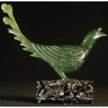 A Chinese spinach jade box and cover, carved as a bird, hardwood stand, 12cm high