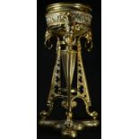 A 19th century gilt brass triform table lamp base, in the Etruscan Revival taste, palmette frieze