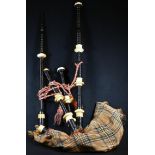 A set of Scottish bagpipes, turned chanter and drones, tartan bag, 107cm long overall