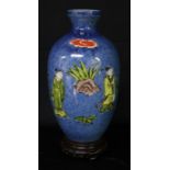 A Chinese ovoid vase, painted in polychrome with figures holding a scroll, beneath a banner