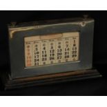 A large George V silver rectangular desk calendar, glazed aperture, oak base, 14cm high, 22cm