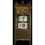 A French gilt metal flip ticket clock, embossed in the Neo-Classical taste with scrolling acanthus