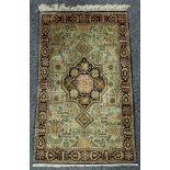A Middle-Eastern Tabriz rectangular carpet, typically close woven with stylized birds, animals,