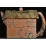 A Chinese Yixing teapot, as a house, rustic branch handle, 14.5cm long, impressed seal mark