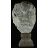 A Medieval limestone corbel carving, of the head of a man, 22cm high, 14cm wide, 13th/14th century